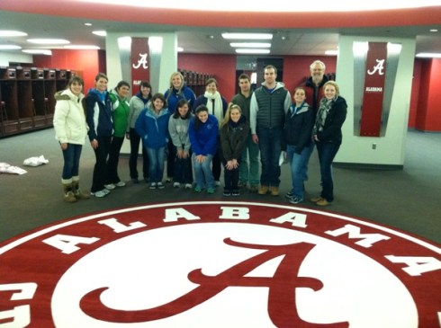 Assumption's 2013 team in Bama locker room, next to sacred seal on which only Nick Saban may trod.