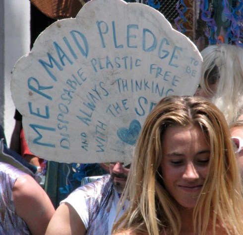 Mermaids with a message proceed down State Street.