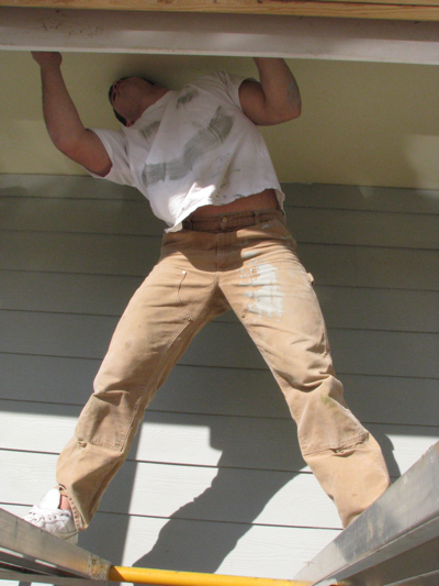 Nick Finan at work on 2011 Habitat house, smiley face courtesy of his co-workers.